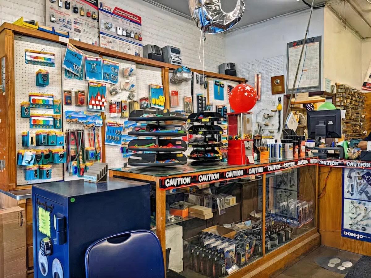 Inside the Central Key & Safe shop: pegboard walls of lock hardware, key blanks, and safes behind the retail counter
